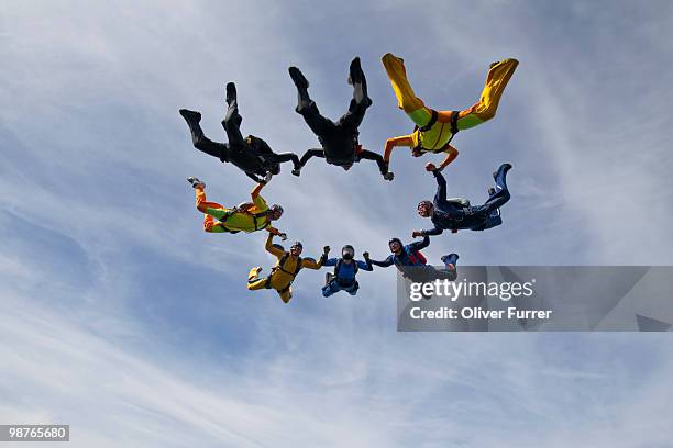 formation divers holding hands in the sky. - saanen stock pictures, royalty-free photos & images