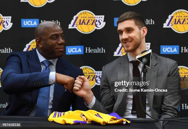 The Los Angeles Lakers 2018 draft pick Sviatoslav Mykhailiuk gets a fist pump from president of basketball operations Magic Johnson during a press...