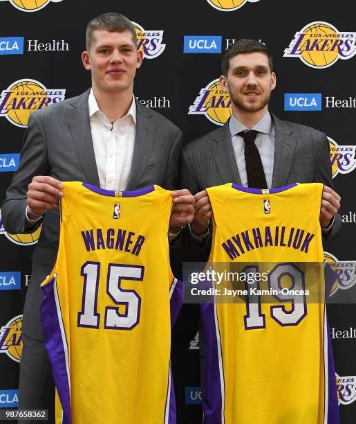 Moritz Wagner and Sviatoslav Mykhailiuk of the Los Angeles Lakers, the team's 2018 NBA draft picks, hold their jersey's during an introductory press...