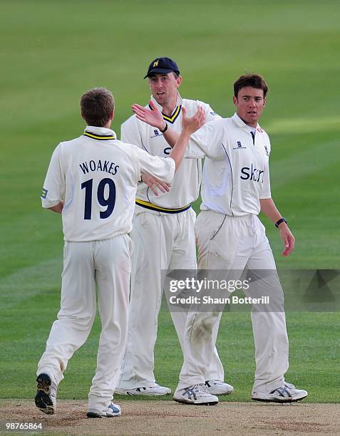 Neil Carter of Warwickshire is congratulated by team-mates Rikki Clarke and Chris Woakes after taking the final Hampshire wicket during the LV County...