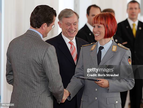 German President Horst Koehler and German Defense Minister Karl-Theodor zu Guttenberg award German biathlete Kati Wilhelm at the Silbernes...