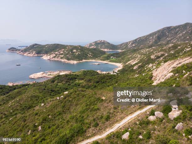 stunning aerial view of the rugged coast of lamma island toward the shek pai wan bay and village in hong kong, china sar. - didier marti stock pictures, royalty-free photos & images