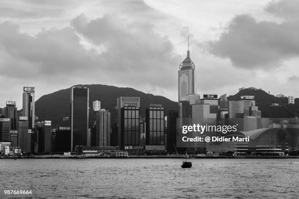 black and white view of the famous hong kong island financial district skyline from kowloon across the victoria harbor - didier marti stock pictures, royalty-free photos & images