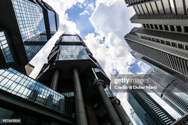 low angle view of skyscraper and luxury hotel towers in hong kong island central district with a dramatic sky in hong kong - didier marti stock pictures, royalty-free photos & images