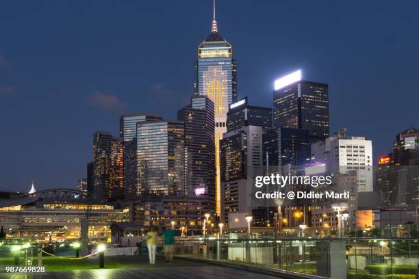 twilight over the skyscraper of the wanchai business district in hong kong island - didier marti stock pictures, royalty-free photos & images