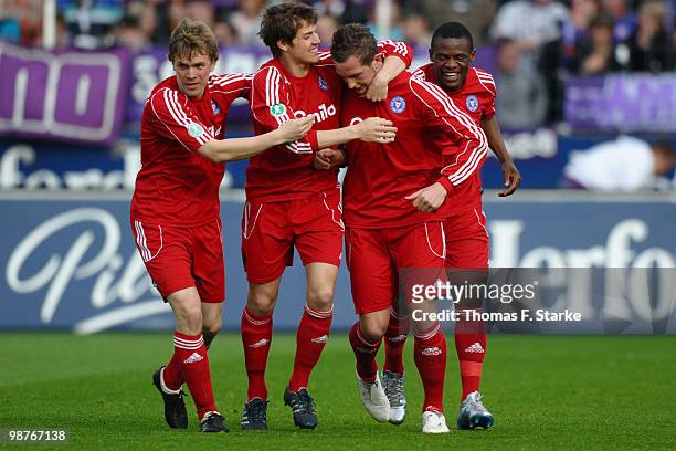 Christopher Lamprecht, Tim Siedschlag, Marc Heider and Francky Sembolo of Kiel celebrate during the Third League match between VfL Osnabrueck and...