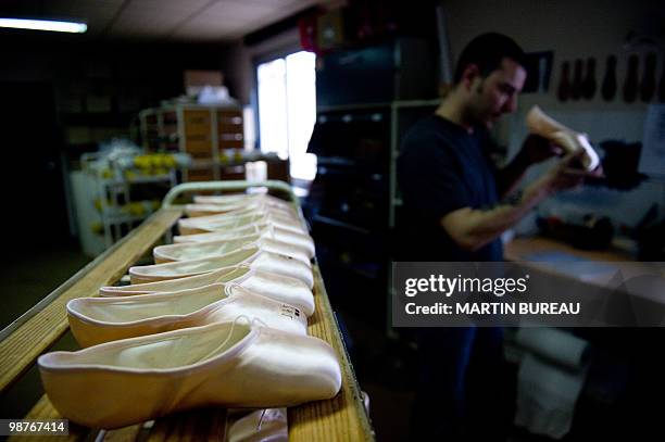 Man adjusts a ballet shoe at the Repetto workshop on March 25, 2010 in Saint-Medard d'Excideuil, central France. Created in 1947 by Rose Repetto, at...