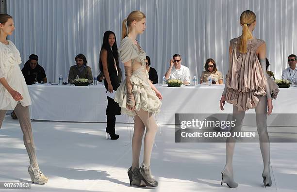 Belgian designer Dries van Noten watches models presenting creations by Chinese born French designer Yiquing Yin , as jury president of the 25th...