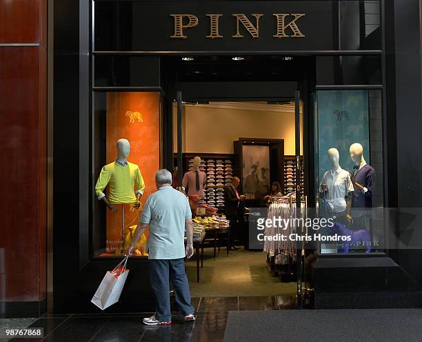 Man looks at a clothing store display at The Shops at Columbus Circle, an upscale mall, April 30, 2010 in New York, New York. The US economy grew...