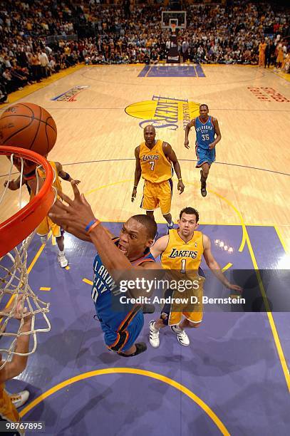 Russell Westbrook of the Oklahoma City Thunder lays the ball up over Jordan Farmar of the Los Angeles Lakers in Game Five of the Western Conference...