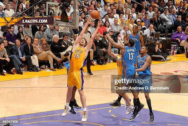 Pau Gasol of the Los Angeles Lakers grabs a rebound over James Harden of the Oklahoma City Thunder in Game Five of the Western Conference...