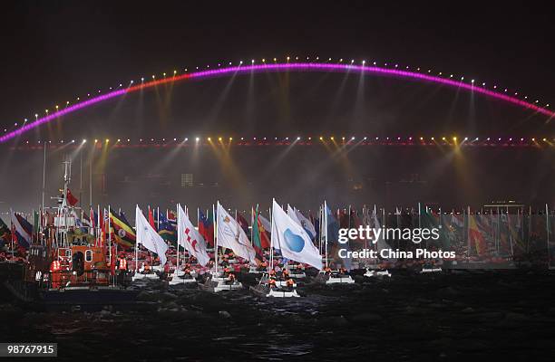 Boats flying the flags of various nations and organizations sail down the Huangpu River during the opening ceremony of the 2010 World Expo on April...