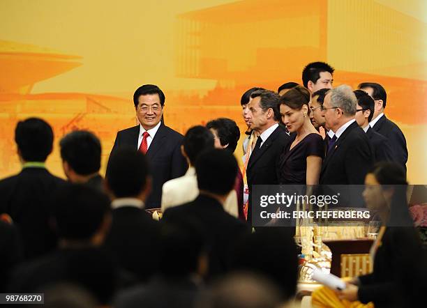 Chinese President Hu Jintao , French President Nicolas Sarkozy , his wife Carla Bruni-Sarkozy and Jean Pierre Laffond arrive at the banquet of the...