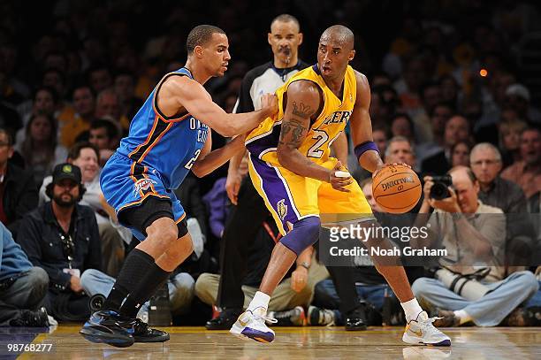 Kobe Bryant of the Los Angeles Lakers handles the ball against Thabo Sefolosha of the Oklahoma City Thunder in Game Five of the Western Conference...