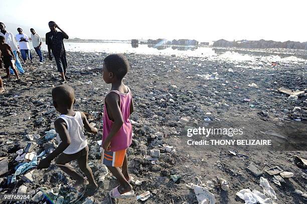 Haitian orphan play amid the garbage in Cite Soleil, the biggest slum in Port-Au-Prince April 28 ,2010. Orphans from the January 12, 2010 earthquake...