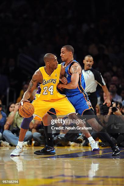 Kobe Bryant of the Los Angeles Lakers handles the ball against Thabo Sefolosha of the Oklahoma City Thunder in Game Five of the Western Conference...