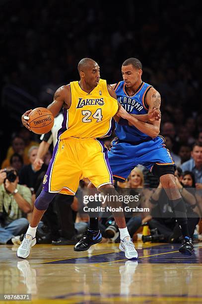 Kobe Bryant of the Los Angeles Lakers handles the ball against Thabo Sefolosha of the Oklahoma City Thunder in Game Five of the Western Conference...