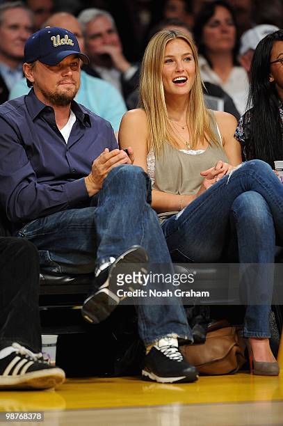 Actor Leonardo DiCaprio and model Bar Refaeli sit courtside during Game Five of the Western Conference Quarterfinals between the Oklahoma City...