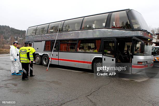 Technical personnel investigate the bus in which 15 year old French exchange student was killed at Roa, approximately 100km north of Oslo, on April...