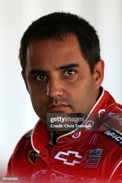 Juan Pablo Montoya driver of the Target Chevrolet stands in the garage during practice for the Crown Royal Presents The Heath Calhoun 400 at Richmond...