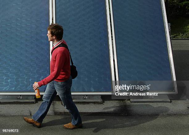 Man walks past a solar-thermic system on the rooftop of a factory on April 30, 2010 in Berlin, Germany. Germany has invested heavily in solar and...