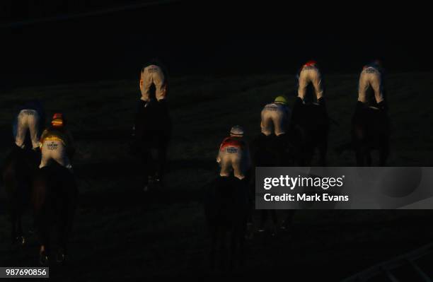 Jockeys are caught in the late afternoon light after race 9 during Sydney racing at Rosehill Gardens on June 30, 2018 in Sydney, Australia.