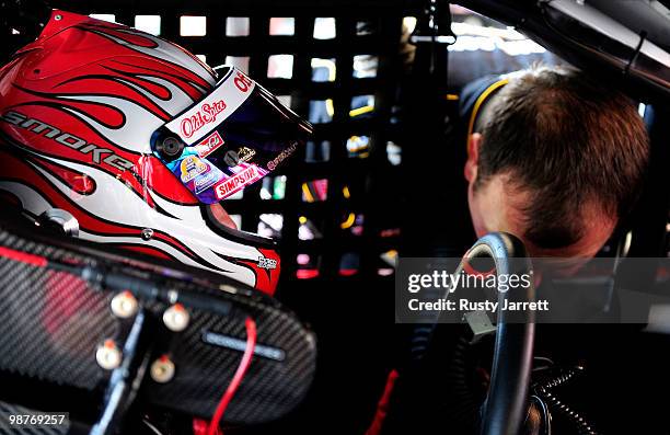 Tony Stewart, driver of the Office Depot/Old Spice Chevrolet, watches Ryan Newman, driver of the US Army Chevrolet try to get his head out of his car...