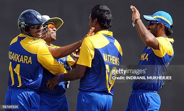 Sri Lankan cricketer Lasith Malinga is congratulated by teammates after he took the catch of Brendon McCullam of New Zealand during their ICC World...