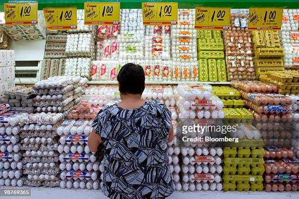 Patron looks at eggs on display at a Chedraui grocery store in Mexico City, Mexico, on Friday, April 30, 2010. Mexican retailer Grupo Comercial...