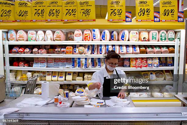 An employee cuts cheese at a Chedraui grocery store in Mexico City, Mexico, on Friday, April 30, 2010. Mexican retailer Grupo Comercial Chedraui SAB...