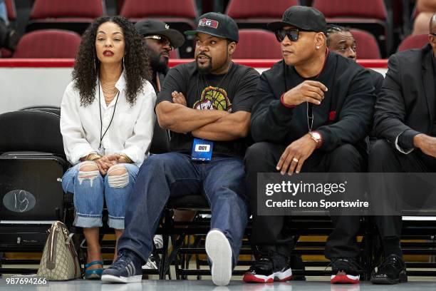 League Co-Founder and entertainer, Ice Cube, watches the game with his wife Kimberly Woodruff and rapper and entertainer LL Cool J during a game in...