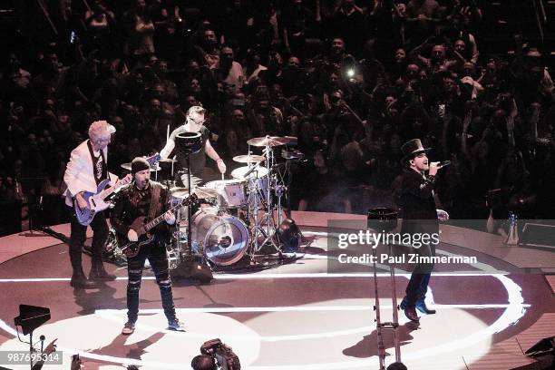 The Edge, Larry Mullen, Jr., Bono, and Adam Clayton of U2 perform onstage during the eXPERIENCE + iNNOCENCE TOUR at Prudential Center on June 29,...