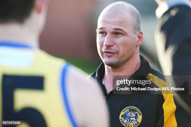 Sandringham coach Aaron Hamill speaks to his players during the round 13 VFL match between Port Melbourne and Sandringham at North Port Oval on June...