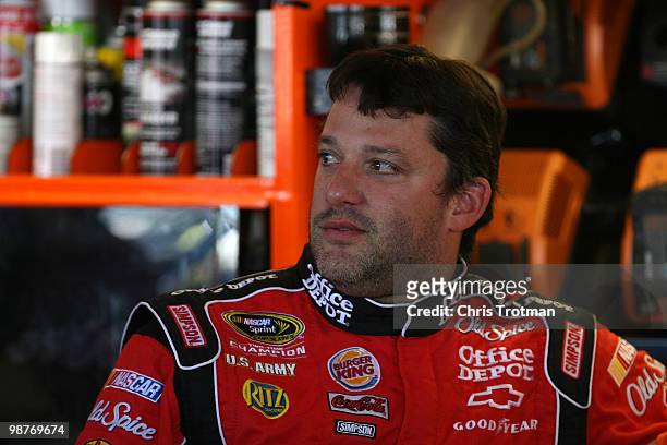 Tony Stewart, driver of the Office Depot / Old Spice Chevrolet, looks on in the garage during practice for the Sprint Cup Series CROWN ROYAL Presents...