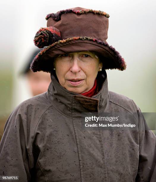 Princess Anne, The Princess Royal wears a hat and raincoat as she gets caught in a rain shower whilst attending the Badminton Horse Trials on April...