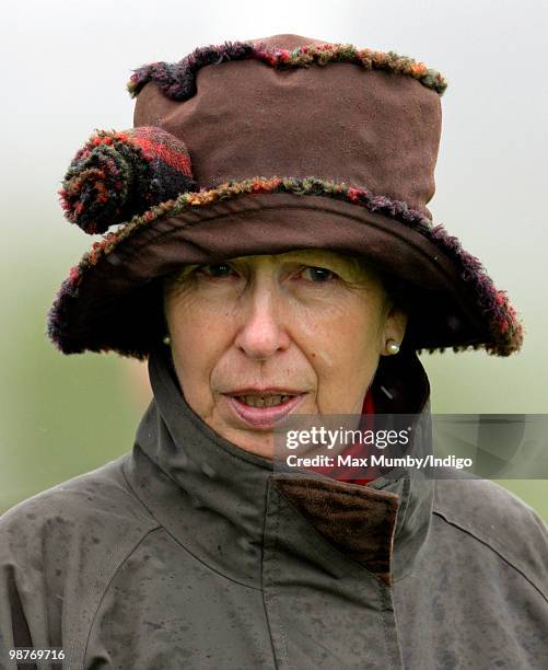 Princess Anne, The Princess Royal wears a hat and raincoat as she gets caught in a rain shower whilst attending the Badminton Horse Trials on April...
