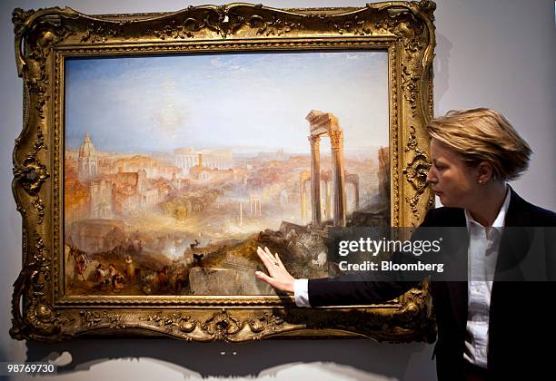 Emmeline Hallmark, head of British paintings at Sotheby's describes J.M.W. Turner's "Modern Rome - Campo Vaccino," during a press preview at...