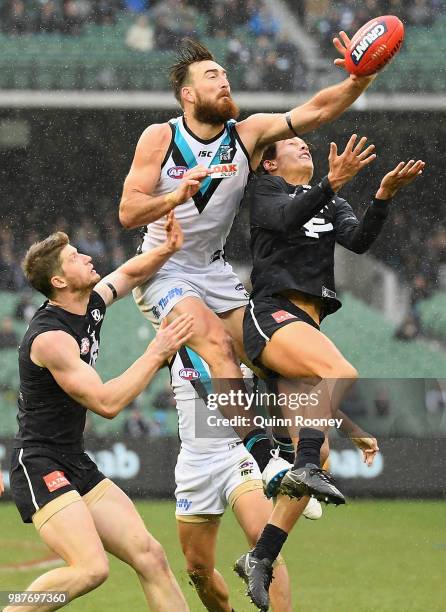 Charlie Dixon of the Power and Jack Silvagni of the Blues compete for a mark during the round 15 AFL match between the Carlton Blues and the Port...