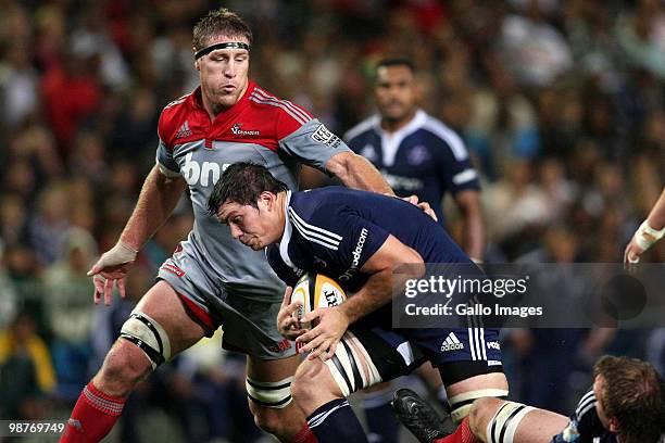 Stormers flank Francois Louw attempts to break clear as Crusaders lock Brad Thorn looks on during the Super 14 match between Vodacom Stormers and...