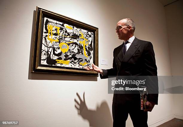 Anthony Grant, executive vice president of contemporary art at Sotheby's, describes Jackson Pollock's "Number 12A, 1948: Yellow, Gray, Black," during...