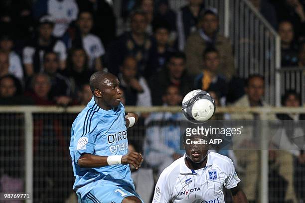Auxerre's Kenyan forward Dennis Oliech vies with Marseille's Cameroonian midfielder Stephane Mbia during their French L1 football match Auxerre vs...