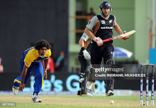 Sri Lankan cricketer Lasith Malinga attempts to run out New Zealand Daniel Vettori during their ICC World Twenty20 2010 match at the Providence...