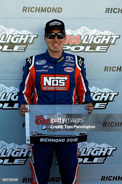 Kyle Busch, driver of the NOS Energy Drink TOyota, poses with his pole ward after qualifying first for the Nationwide Series BUBBA burger 250 at...