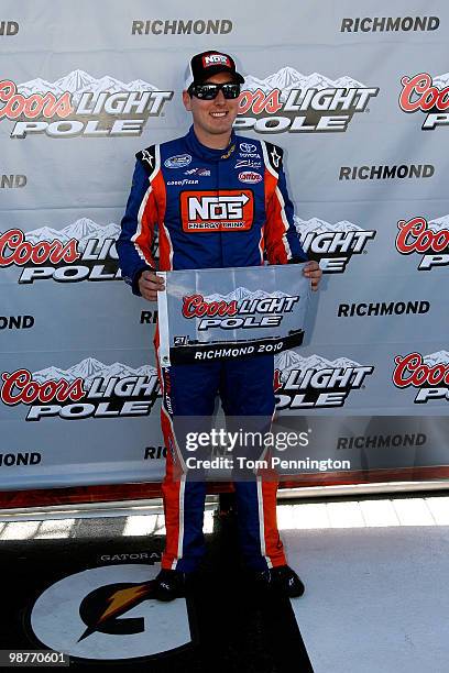 Kyle Busch, driver of the NOS Energy Drink TOyota, poses with his pole ward after qualifying first for the Nationwide Series BUBBA burger 250 at...