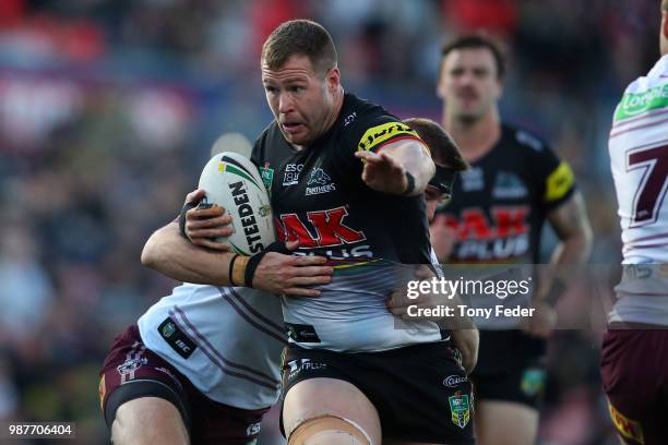 Trent Merrin of the Panthers is tackled during the round 16 NRL match between the Penrith Panthers and the Manly Sea Eagles at Panthers Stadium on...