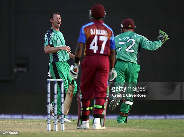 Alex Cusack of Ireland celebrates catching Dwayne Bravo of the West Indies off his own bowling during the ICC T20 World Cup Group D match between...