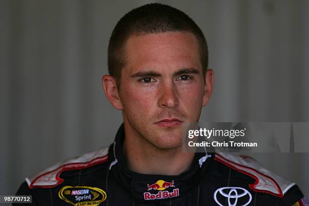 Scott Speed, driver of the Red Bull Toyota, looks on in the garage during practice for the NASCAR Sprint Cup Series CROWN ROYAL Presents The Heath...