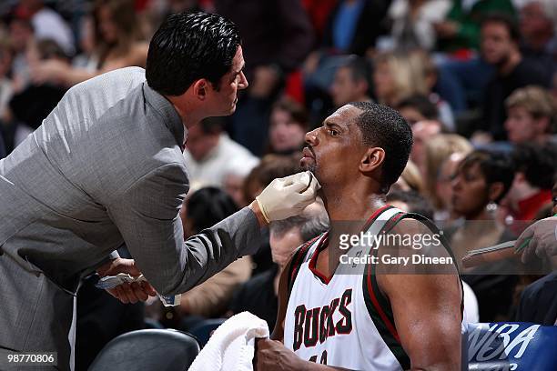 Trainer Marc Boff attends to Kurt Thomas of the Milwaukee Bucks in Game Three of the Eastern Conference Quarterfinals against the Atlanta Hawks of...
