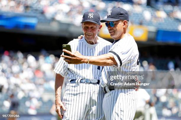 Former players Dr. Bobby Brown and Reggie Jackson of the New York Yankees take a selfie during the New York Yankees 72nd Old Timers Day game before...