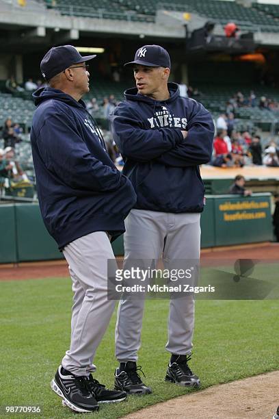 Manager Joe Girardi of the New York Yankees and Special Assistant Reggie Jackson standing on the field prior to the game against the Oakland...